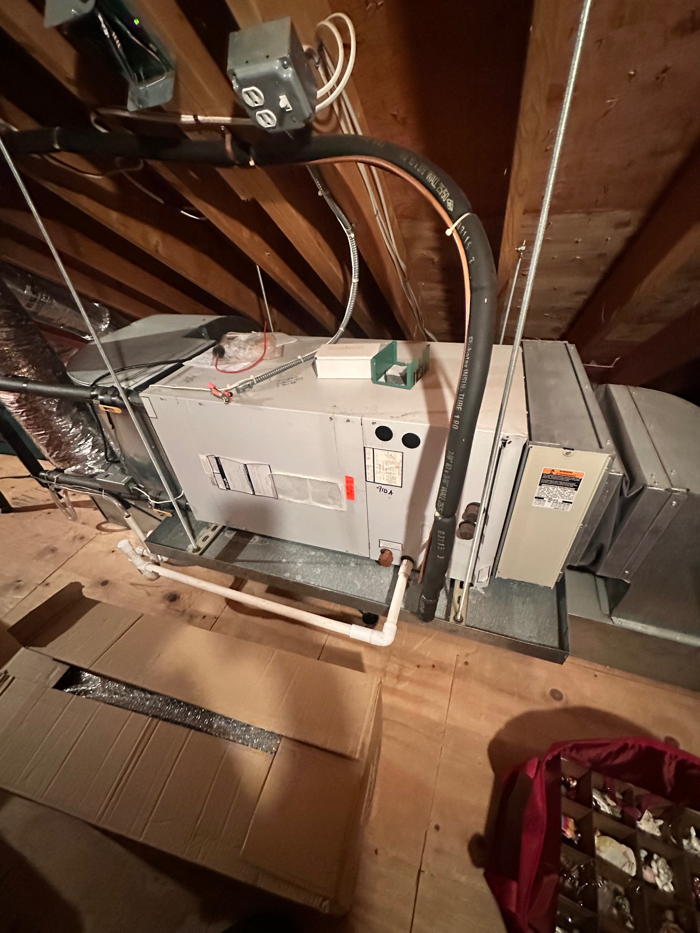 Packaged attic HVAC unit with refrigerant lines and condensate pump