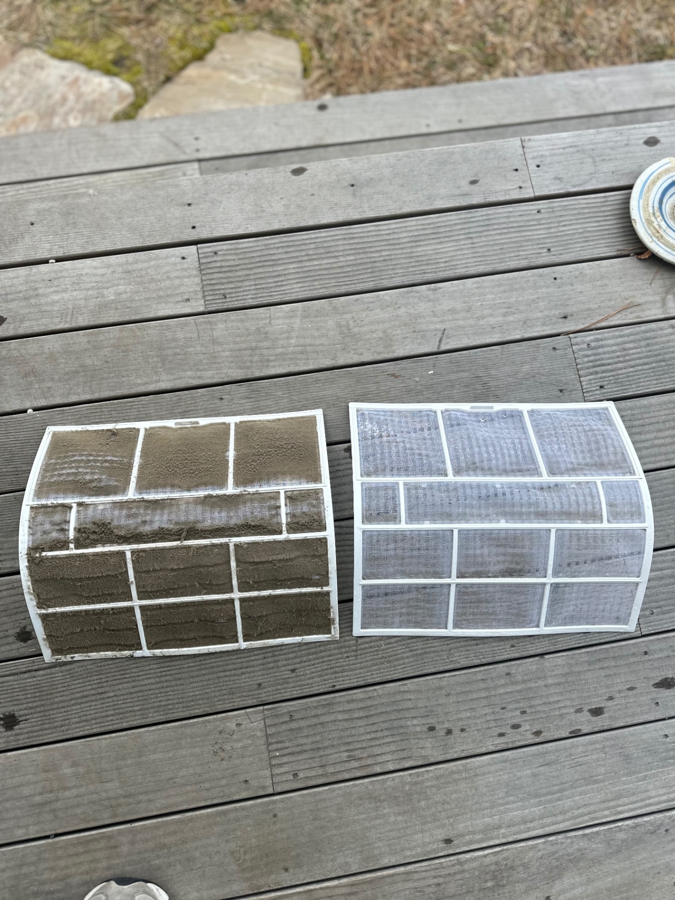 Dirty mini-split filter next to a freshly cleaned one